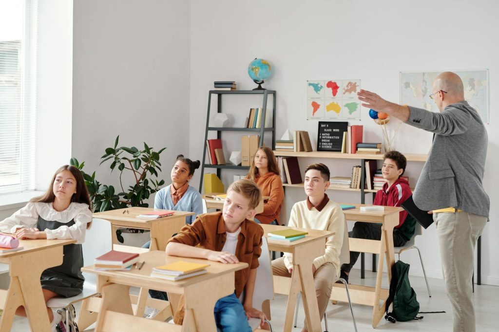 children in a classroom looking forward as they are seated in their desks