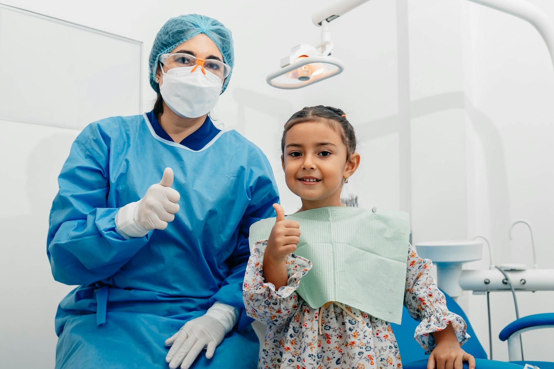 dentist and her patient posing at the camera